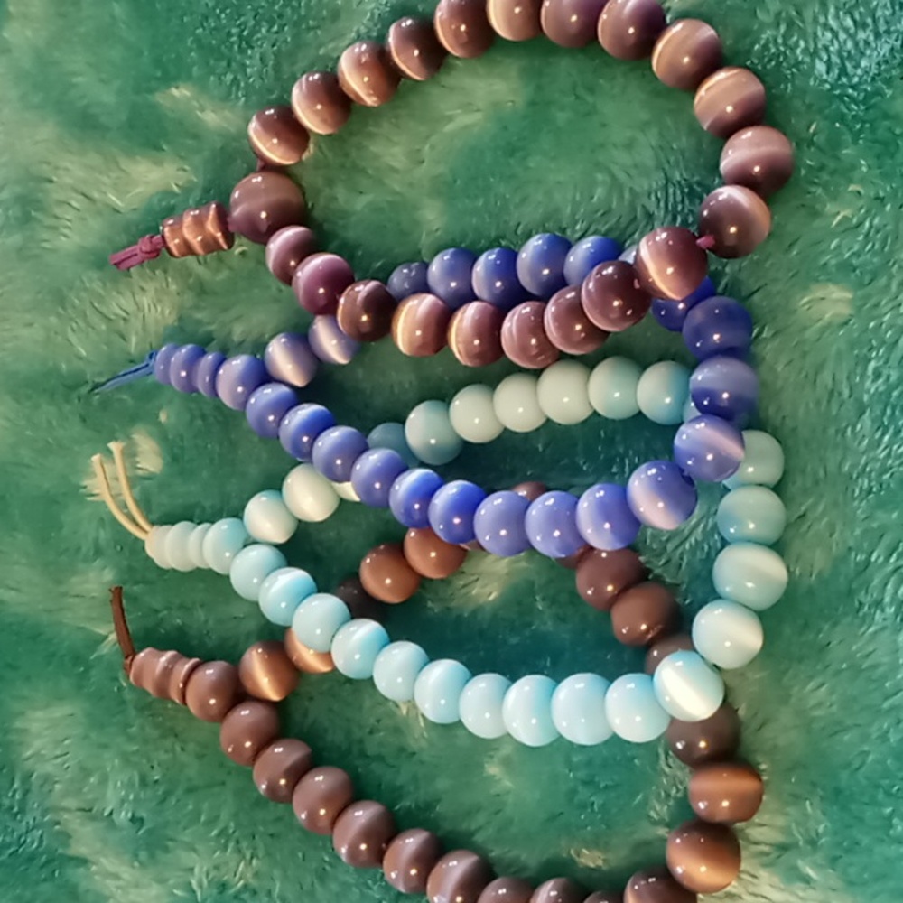 4 beaded cats eye quartz like bracelets 4 different colors. Adjustable